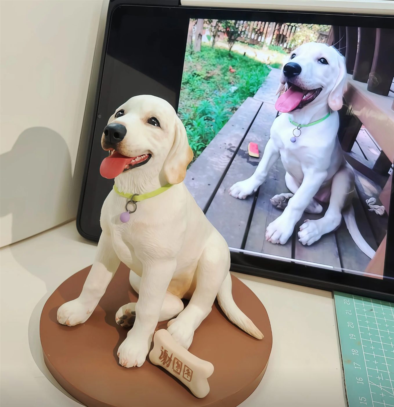custom dog figurine displayed beside a reference pet photo