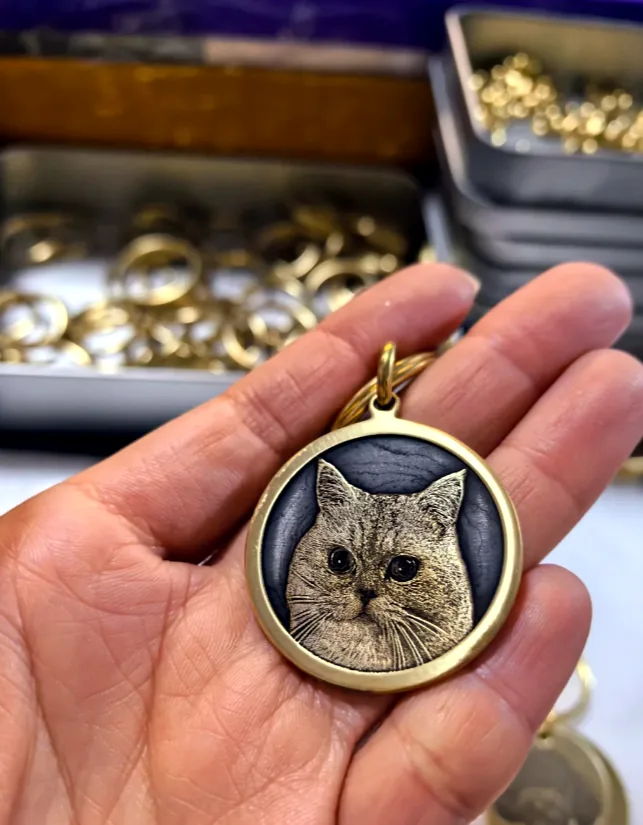 custom engraved cat memorial medallion held in hand